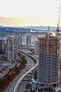 High angle view of road amidst buildings in city against sky