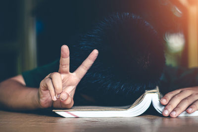 Close-up of person hand on table
