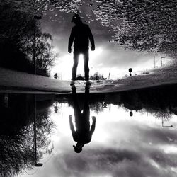 Reflection of man in water