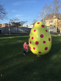 Boy in park against sky in city