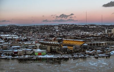 Aerial view of cityscape against sky during sunset