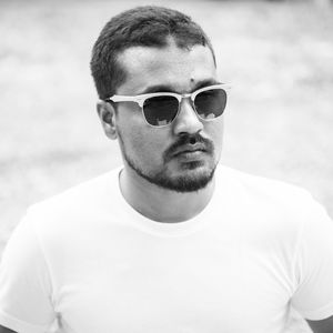 Black and white portrait of young man wearing sunglasses
