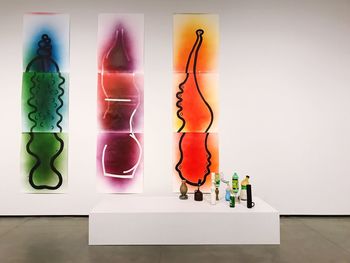 Close-up of multi colored candles on wall