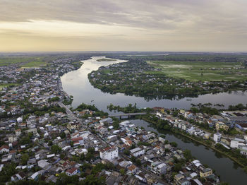 High angle view of townscape by sea against sky