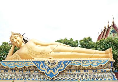 Low angle view of buddha statue against clear sky