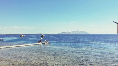 Scenic view of sea against clear blue sky