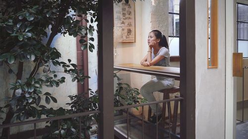 Young woman sitting at home