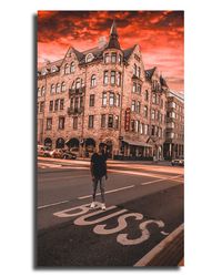 Rear view of man walking on street against buildings in city