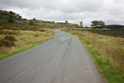 Empty road along countryside landscape