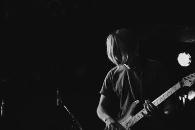 Man playing guitar at night