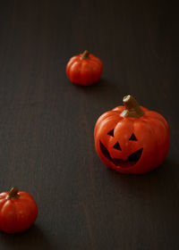 Orange tomatoes on table