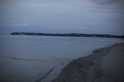 Scenic view of sea against sky at dusk