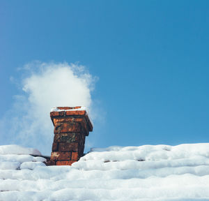 Low angle view of snow on field against sky