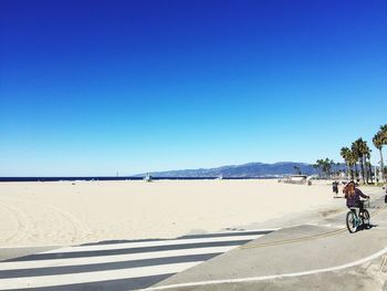 People on road against clear sky