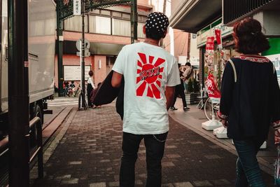 Rear view of people walking on street