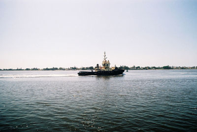 Ship in sea against clear sky