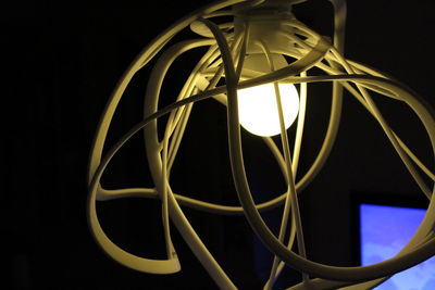 Close-up of illuminated lamp against black background