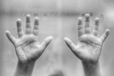 Humans hands on a glass in a shower