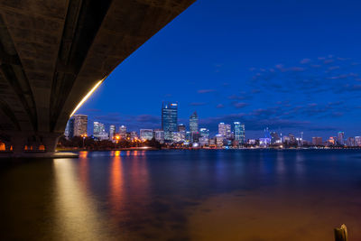 Illuminated city at waterfront