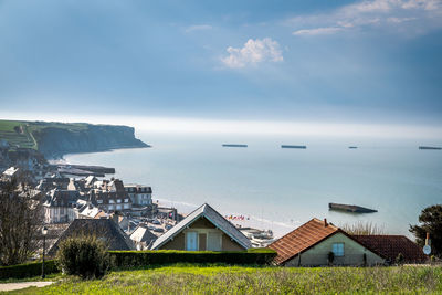 High angle view of buildings by sea against sky