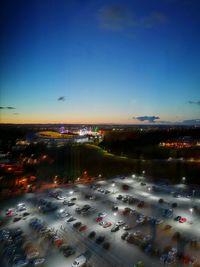 High angle view of illuminated cityscape against sky at night