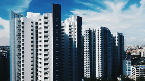 View of skyscrapers against cloudy sky