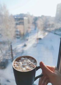 Hand holding coffee cup