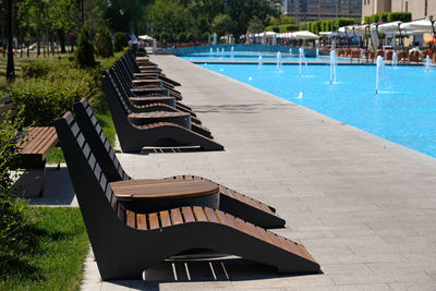 Recreation and relaxation area by the pool in hotel. row of water jets in modern fountain  in park