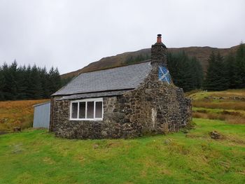 House on field against sky