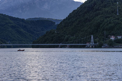 Scenic view of river by mountains
