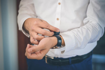 Midsection of man wearing wrist watch