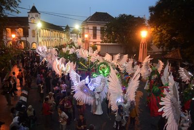 Crowd in city against sky at night