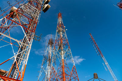 Group of telecommunication towers with blue sky background.