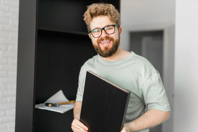 Portrait of senior man using digital tablet while sitting at home