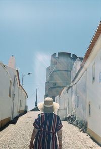 Rear view of person standing against sky