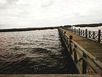 Pier over sea against sky