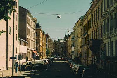 Traffic on road amidst buildings in city