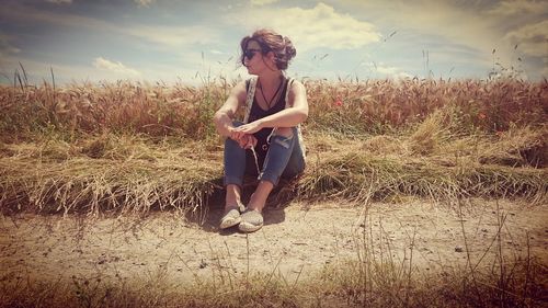 Portrait of woman standing against sky