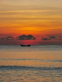 Scenic view of sea against orange sky