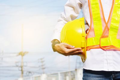 Midsection of man working with umbrella