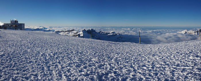 Panoramic shot of frozen landscape against blue sky