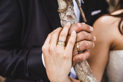 Midsection of couple holding hands