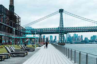 View of suspension bridge against cloudy sky