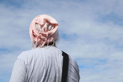 Rear view of man standing against sky