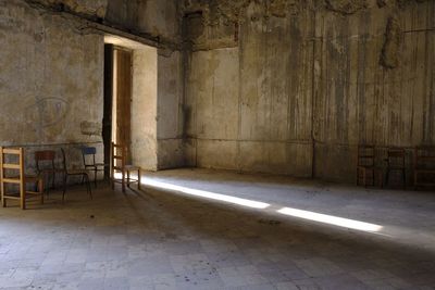 Empty chair in abandoned building