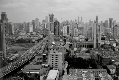 High angle view of modern buildings in city against sky