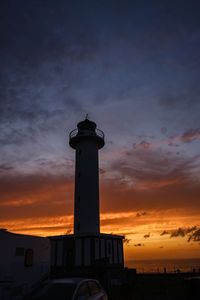 Silhouette lighthouse against sky during sunset