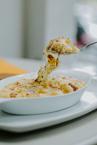 Macroni pasta cooked with creamy sauce, smoked beef, cheese and topped with mozarella cheese