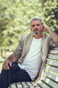 Portrait of man sitting on bench