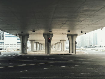 Empty road with bridge structure in background